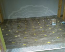 Drywall on back wall because within 2' of property line, tile floor in center section using leveler/spacers.